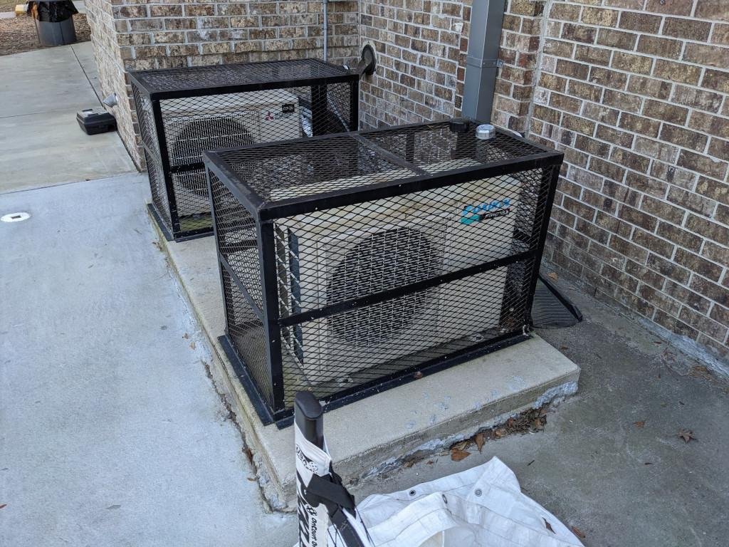 a heat pump in an outdoor cage